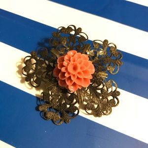 Metal flower brooch with flower detail